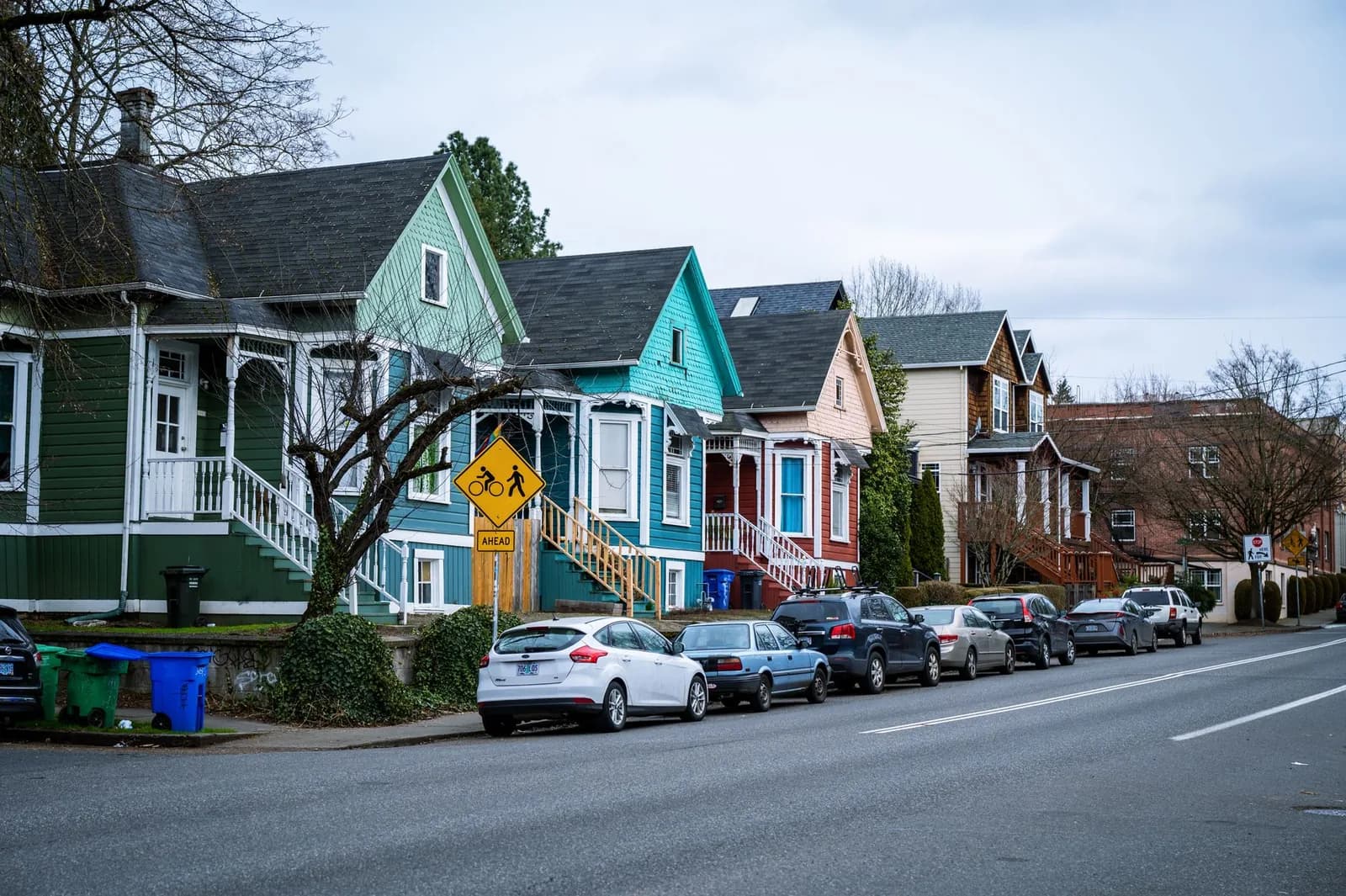 Picturesque street view of colorful, charming houses in a Portland, OR suburb, showcasing urban living.