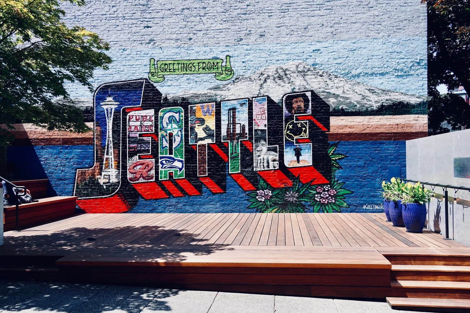 Vibrant mural showcasing Seattle's famous landmarks in a creative street art style.